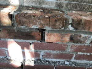 weep hole cover - 100 year old brick wall